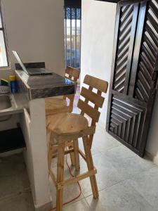 a kitchen with a table and two chairs and a desk at Casa LAGOMAR in Puerto Colombia +8 photos
