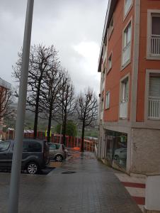 a parking lot with cars parked next to a building at Apartamento Galeguiña in Vigo
