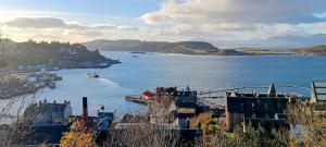 a view of a body of water with a city at Red Deer Cottage at Fanans in Oban