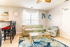 a living room with a couch and a table at Blue Wave Retreat in Heart of Myrtle Beach in Myrtle Beach