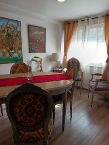a dining room with a table and chairs and a room with at CasaValparaluz in Valparaíso