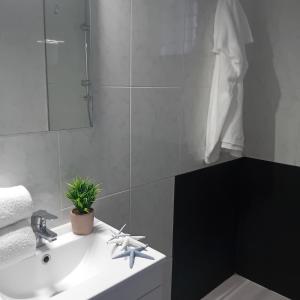 a bathroom with a white sink and a mirror at María PLAYA MAR NG in Peniscola