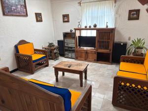a living room filled with furniture and a tv at Casquito de Hacienda in Ezequiel Montes