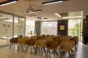 a room with a row of chairs in a room at VVC Hotel's in Villavicencio