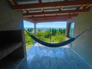 a hammock in a house with a view at Verdena in Villa Amancay