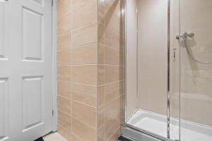 a bathroom with a shower with a glass door at Spacious 1 Bedroom Apartment in Birmingham +24 photos