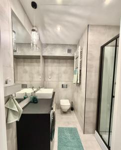 a bathroom with a sink and a toilet at Bliska 17 Warsaw Studio in Warsaw +3 photos