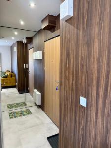 a hallway with wood paneling and a row of elevators at Bliska 17 Warsaw Studio in Warsaw