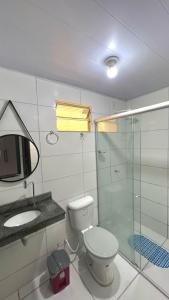 Un baño con inodoro, lavabo y ducha. en Casa confortável em condomínio para a COP 30, en Castanhal