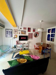 a living room with a couch and a table at Le Nid Des Couleurs in 'Aïn Taya +16 photos