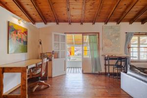 a living room with a table and a couch at Gray Fox Apartments - Ishton in Ushuaia