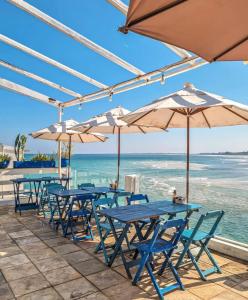 a row of tables and umbrellas on the beach at Céu Beach club in Barra de Guaratiba +2 photos