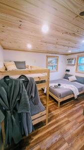 a bedroom with two bunk beds in a cabin at Riversong Cabin - Living Waters Farm in Cleveland