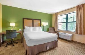 a hotel room with a bed and a desk and window at Extended Stay America Suites - Princeton - West Windsor in Princeton +54 photos