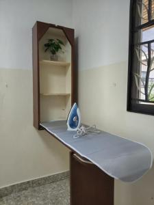 a counter with a mirror and a blue item on it at Spacious Bungalow with Large Outdoor in Sabah in Penampang
