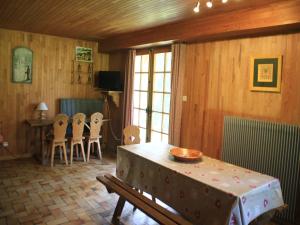a room with a table and chairs and a dining room at Chalet in Vonnes near Chairlifts & Shuttle in Châtel