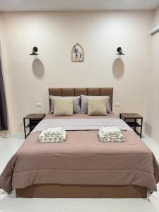 a bedroom with a large bed with two pillows on it at jj home resort in Phun Phin