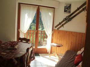 a room with a bed and a window with a table at Jonquilles apartment for 4 people in Châtel
