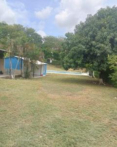 a yard with a pool and a house and trees at Casa de campo rural con piscina fenomenal in El Guabinal