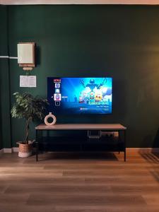 a flat screen tv sitting in a living room at Adwa Guesthouse in Keningau