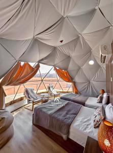 Ένα ή περισσότερα κρεβάτια σε δωμάτιο στο RUM ALIENA LUXURY CAMP & Bubbles Hotel