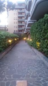 a person walking down a sidewalk in front of a building at Maison Talenti B&B Roma in Rome