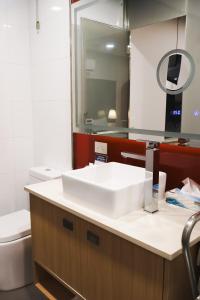 a bathroom with a sink and a toilet at Stay Motel - Formerly Room Motels Gympie in Gympie +22 photos
