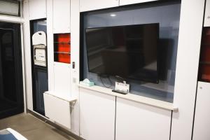 a flat screen tv in a white wall at Stay Motel - Formerly Room Motels Gympie in Gympie