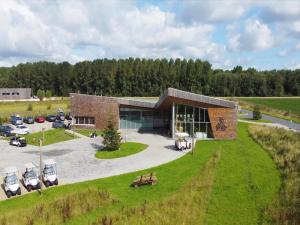 an aerial view of a building with a parking lot at Woodland Retreat for Two in Antoing