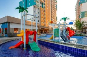 a water park with a playground with a water slide at Hospedagem Olímpia -SP in Olímpia