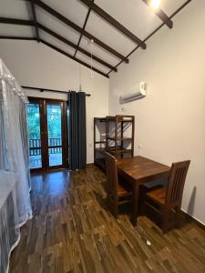 a dining room with a wooden table and chairs at Villa Tanzanite in Tangalle