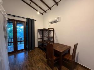 a dining room with a table and a window at Villa Tanzanite in Tangalle