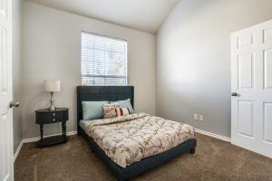 a bedroom with a bed and a window at Gorgeous cozy home in nature serene neighborhood! in DeSoto