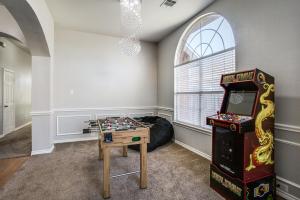 a room with a game table and a arcade machine at Gorgeous cozy home in nature serene neighborhood! in DeSoto