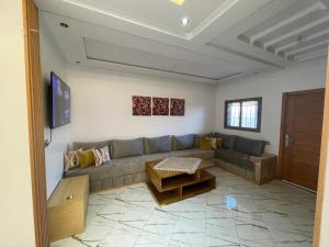 a living room with a couch and a table at maison cotiére in Iterkine