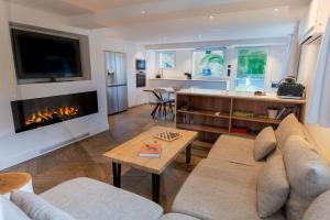 a living room with a couch and a fireplace at APPARTEMENTS LOFT OCEAN - Tarnos in Tarnos