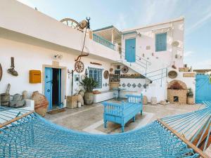 a patio with a blue hammock in a house at El houch الحوش in Port El Kantaoui