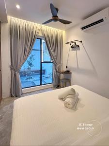 a bedroom with a bed and a large window at Room l 4min Walks to Pelangi Plaza in Johor Bahru