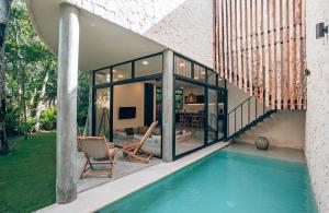 a house with a swimming pool next to a house at Luxury Jungle Villa-Pvt Pool -100mbs- Concierge 8A in Tulum