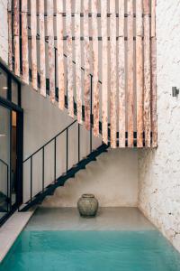 a staircase with a vase in the middle of a building at Luxury Jungle Villa-Pvt Pool -100mbs- Concierge 8A in Tulum