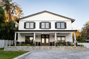a white house with a white fence at The Geneva Lakehouse in Southerland Strip