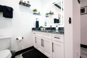 a white bathroom with a sink and a toilet at The Geneva Lakehouse in Southerland Strip +54 photos