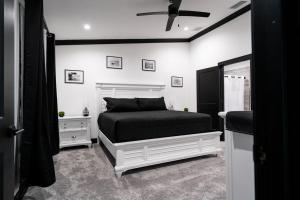 a black and white bedroom with a bed and a window at The Geneva Lakehouse in Southerland Strip