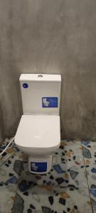 a bathroom with a white toilet in a room at Hill Top Heaven in Hikkaduwa