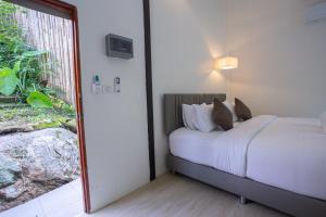 Postel nebo postele na pokoji v ubytování Inthada At Mae Kampong Chiang Mai