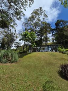 a house on a hill with a yard at Monteverde Casa Mia, near main attractions and town! in Monteverde Costa Rica