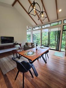 a large living room with a wooden table and chairs at Monteverde Casa Mia, near main attractions and town! in Monteverde Costa Rica