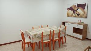 a dining room with a table and chairs and a painting at Vitramu Campana I in Campana +2 photos