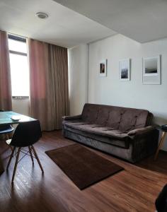 a living room with a couch and a table at Bahia Hotel Sol Vitoria Marina Flats in Salvador +26 photos