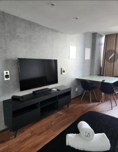 a living room with a flat screen tv on a wall at Bahia Hotel Sol Vitoria Marina Flats in Salvador